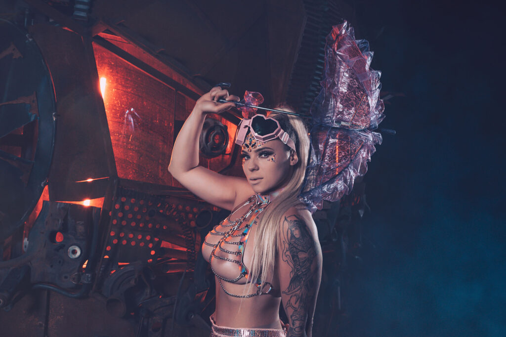 Model with a glowing art car at night — Burning Man series