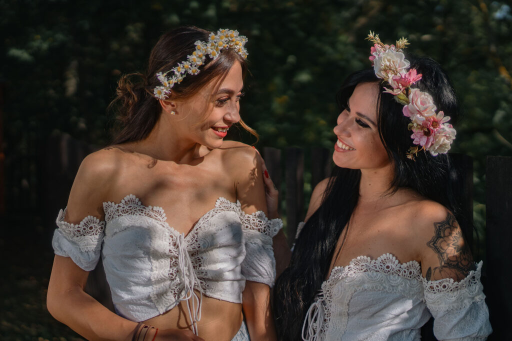 Two models in embroidered folk blouses and flower crowns, HotFolk 2024 calendar