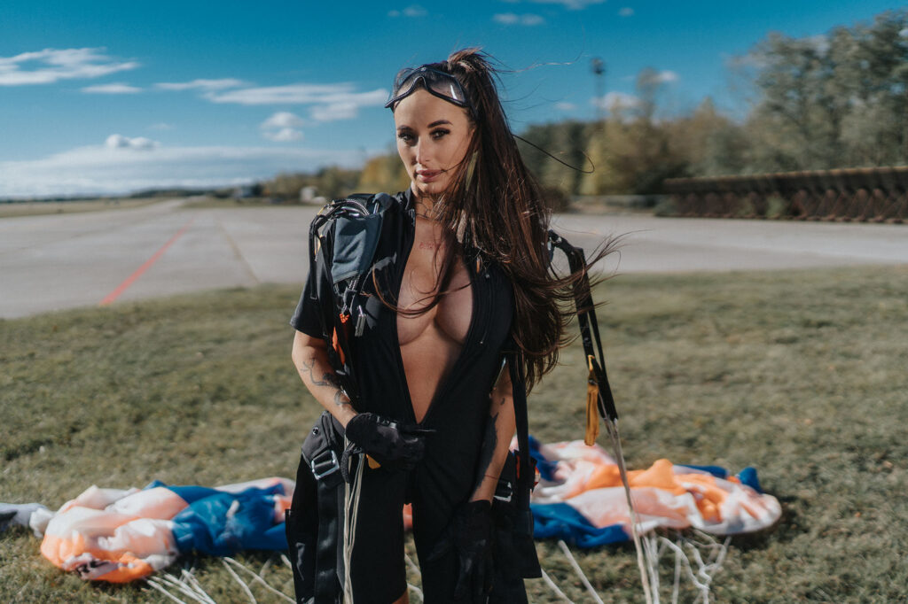 Portrait of a woman with a parachute at an airfield on an autumn day