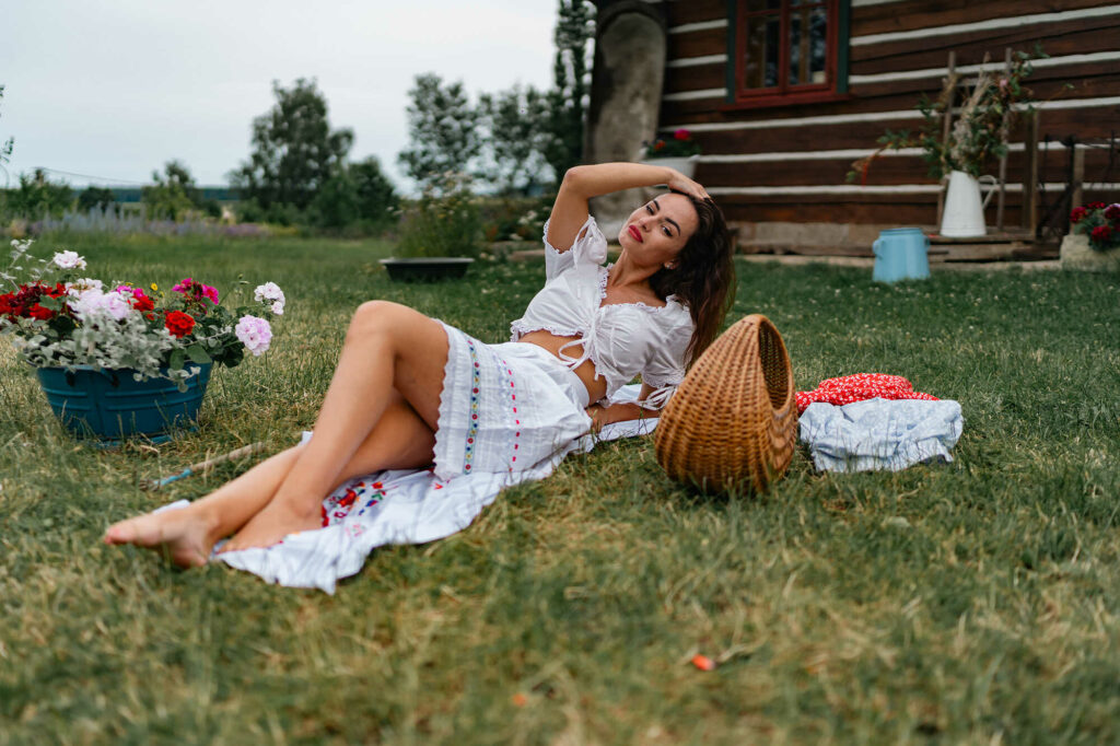 Model Lucie lying on a blanket in the summer grass, HotFolk fine-art calendar shot in the Czech countryside