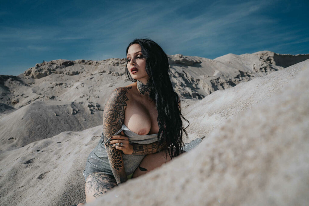 Tereza crouching on a white chalk slope in a silver top