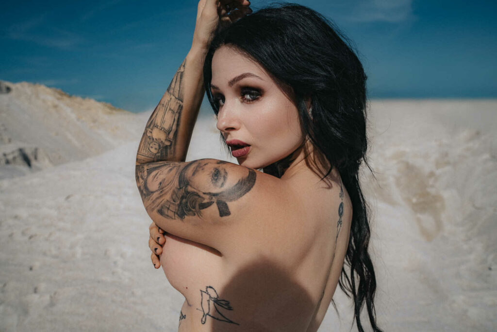 Tereza showing her tattooed shoulder on white chalk hills