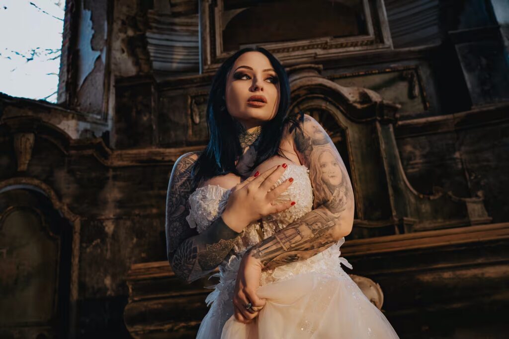 Tattooed Tereza in a lace wedding dress inside a ruined church