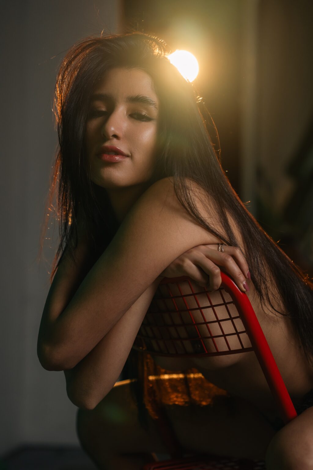 Sofia in a black lace top in warm evening light in a Prague studio