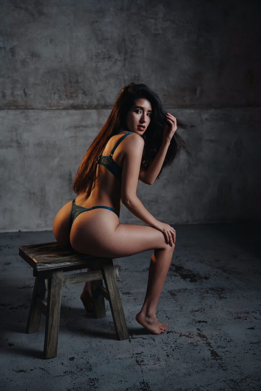 Glamour model Sofia wearing green lingerie in a Prague photography studio