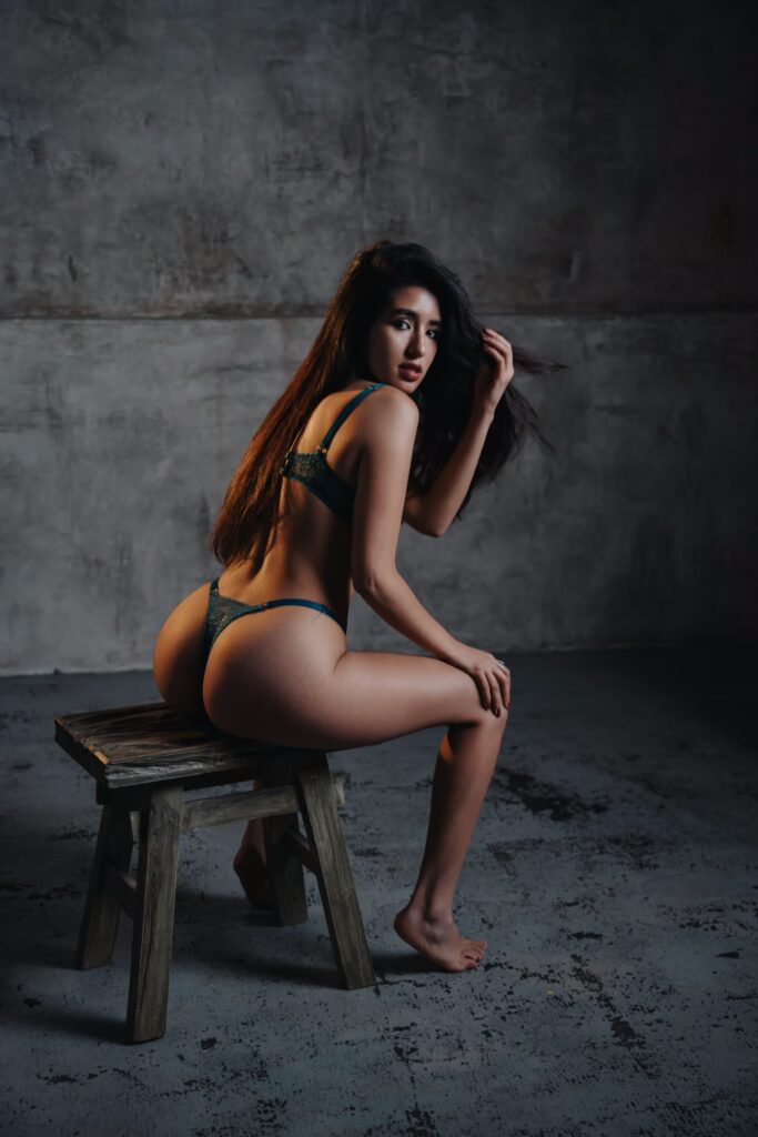 Glamour model Sofia wearing green lingerie in a Prague photography studio