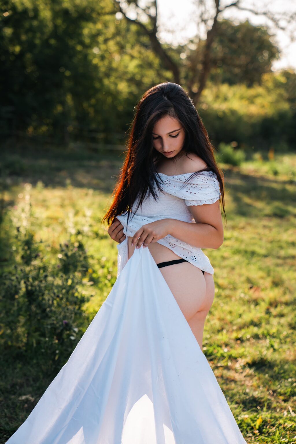 Nikol in white drapery in the garden