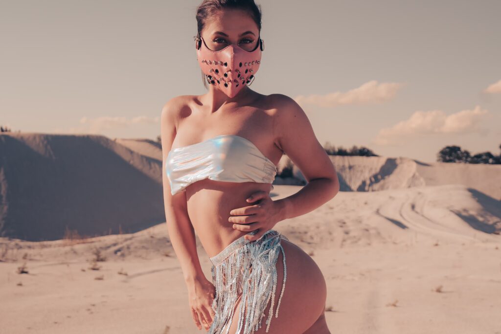 Valerie wearing a silver Burning Man costume on the sand in the desert