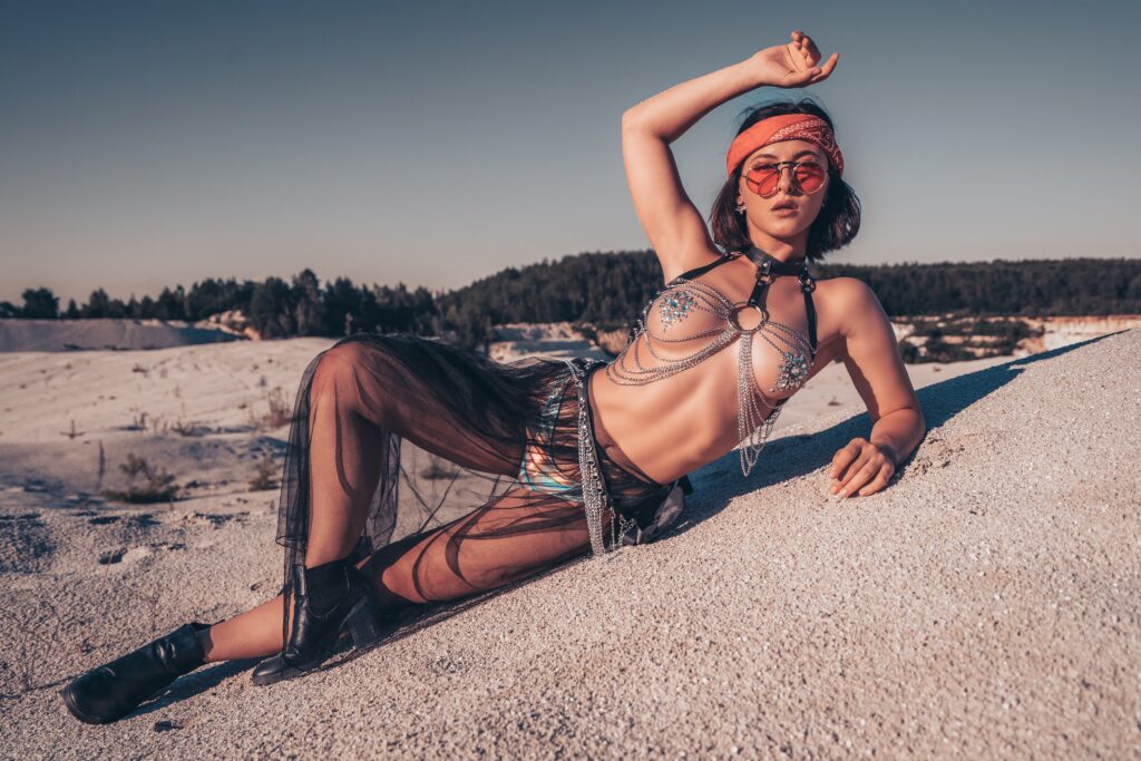 Valerie wearing a festival bra and hat during a desert photoshoot