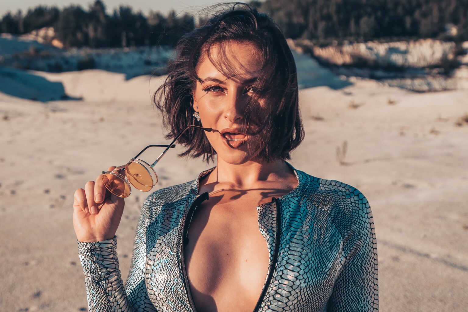 Valerie posing in a Burning Man style outfit in the sunny desert