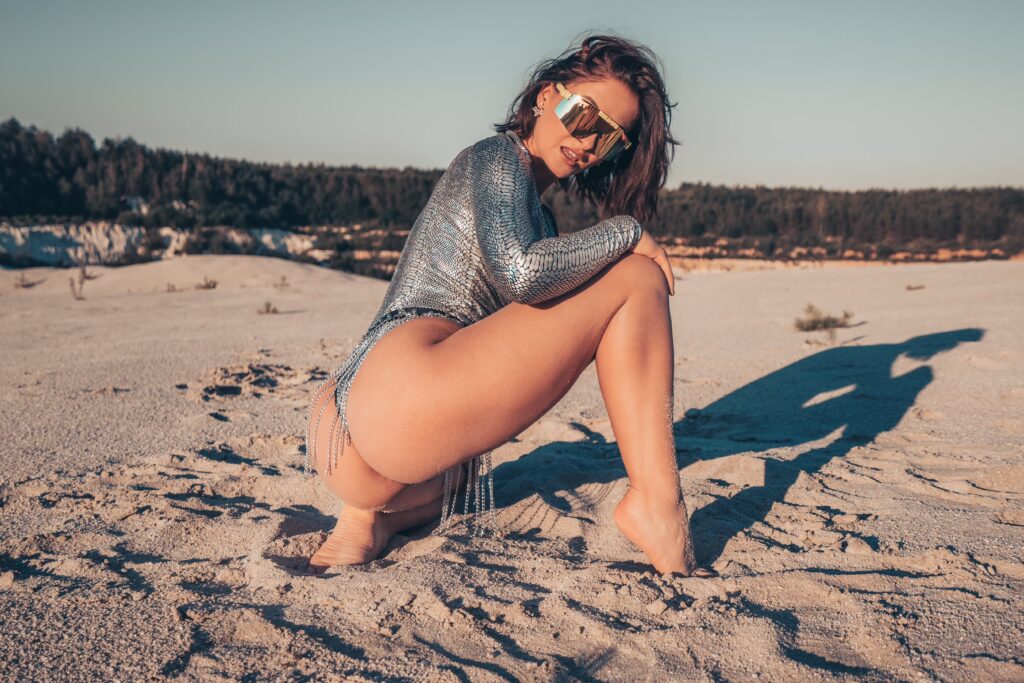 Valerie wearing a festival costume on the sand during a Burning Man inspired photoshoot