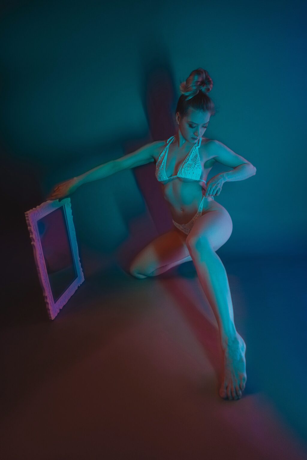 Goddess Isabelle standing in teal studio light