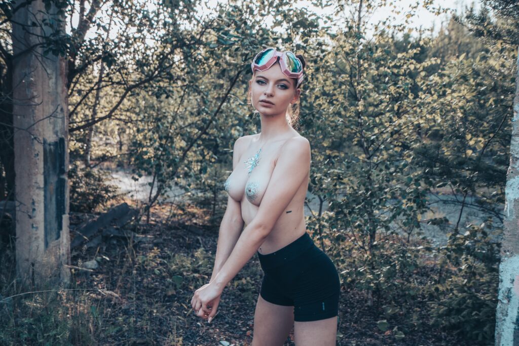 Kortie topless with body glitter during an urbex photoshoot