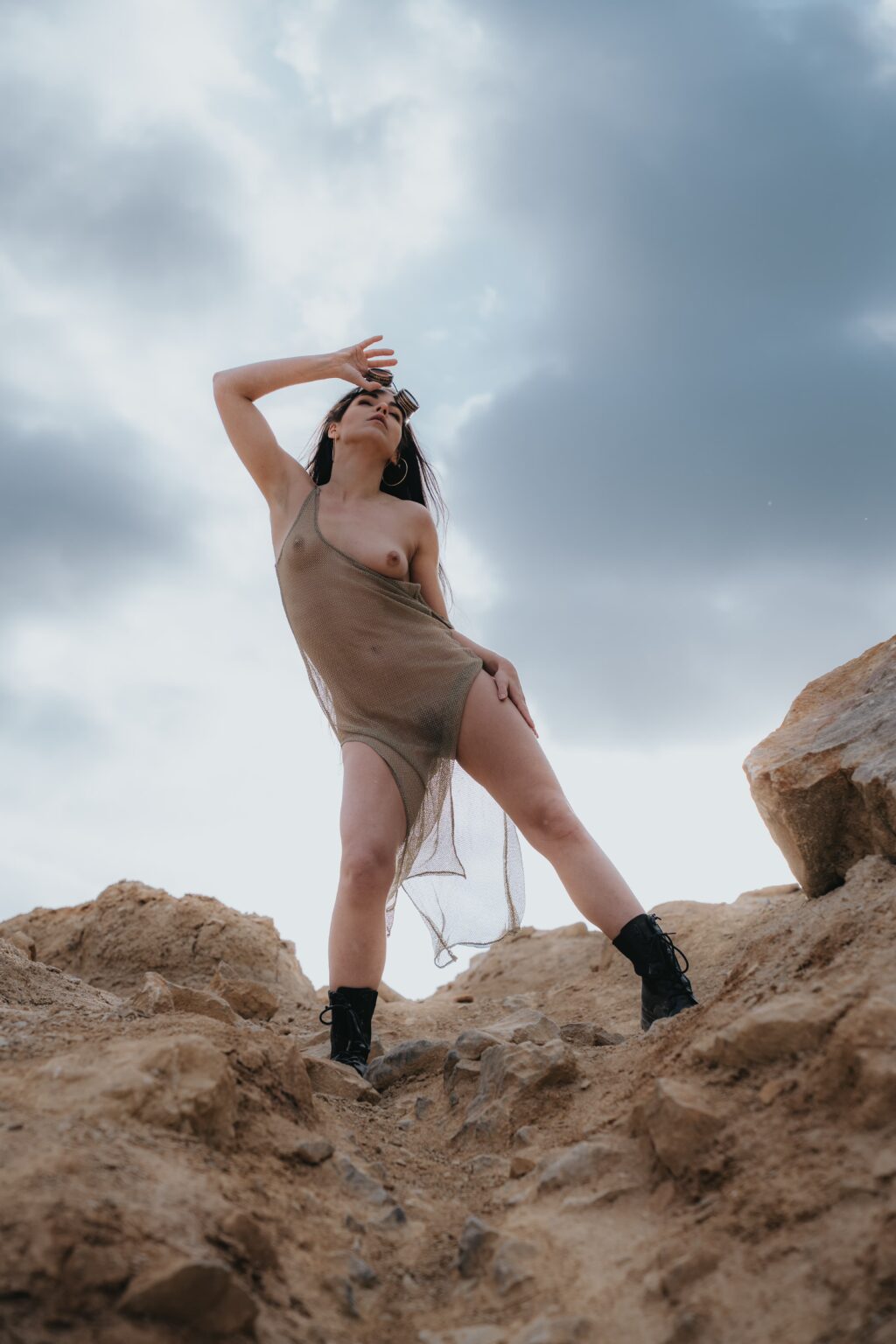 MovenModel in a sheer dress on sandstone rocks